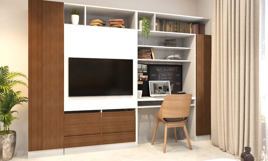 1 bhk apartment living room has a sectional sofa, an entertainment cum study unit