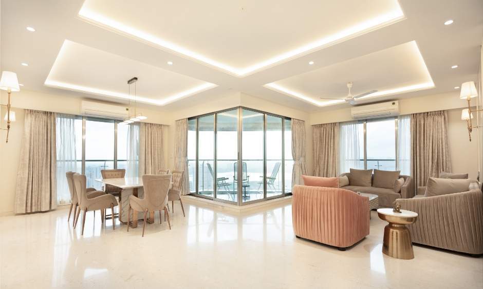 Spacious living-cum-dining area with comfortable seating and a false ceiling in Raj Grandeur, Mumbai