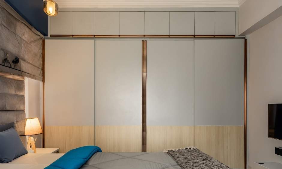 Elegant 4-door sliding wardrobe in white with gold accents and loft storage in Kandivali West, Mumbai.