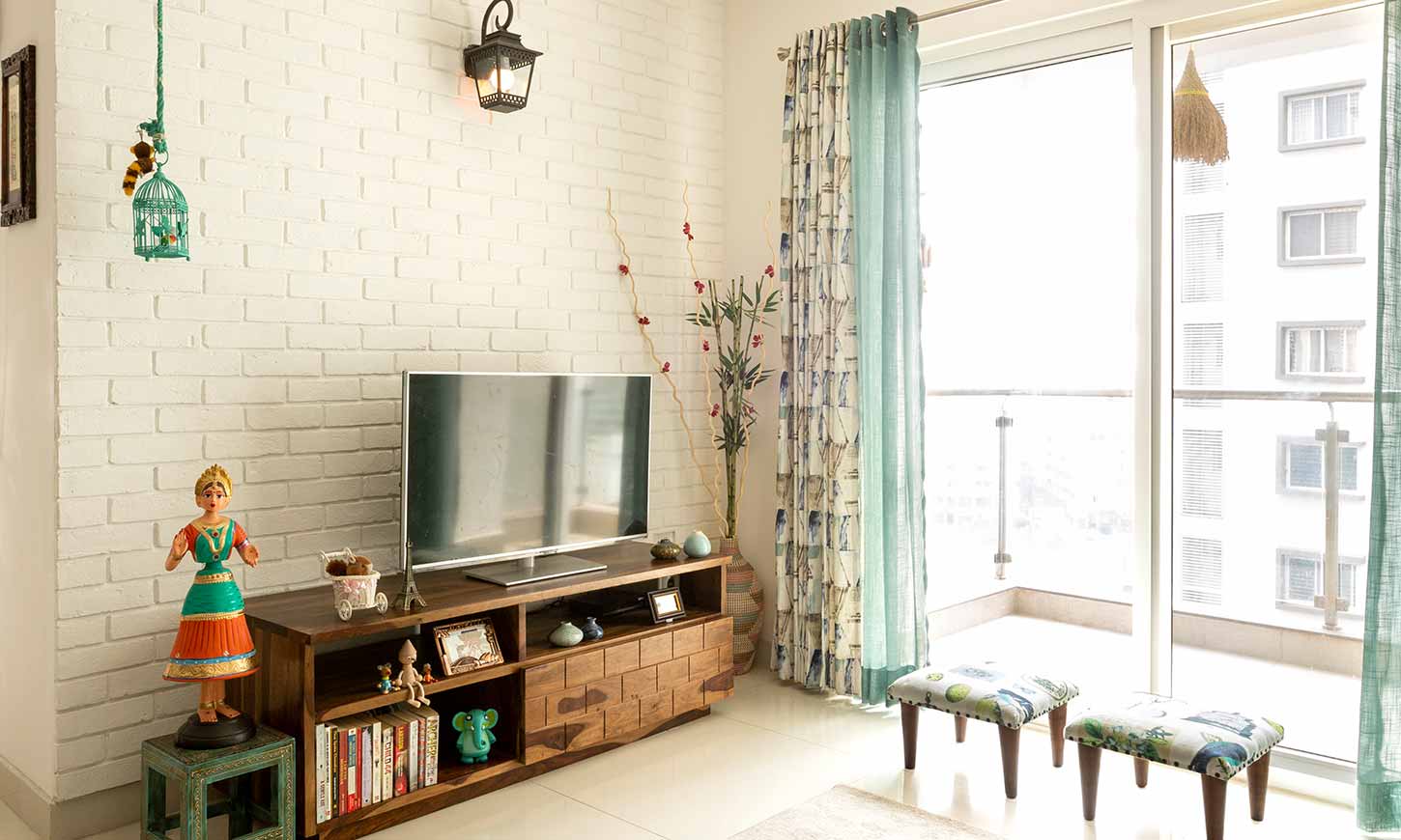 Living room interior wih small tv unit designed by affordable interior designers in bangalore