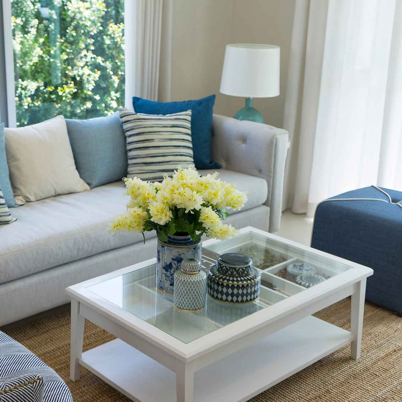 Use sand-coloured fabrics and driftwood accents to complement the beach style living room interiors