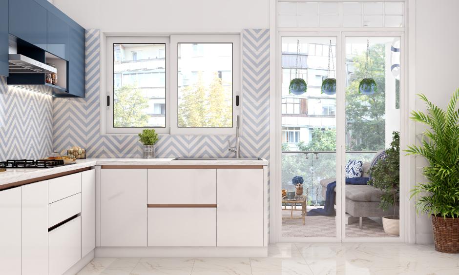Blue and white herringbone kitchen wall tiles and white cabinets