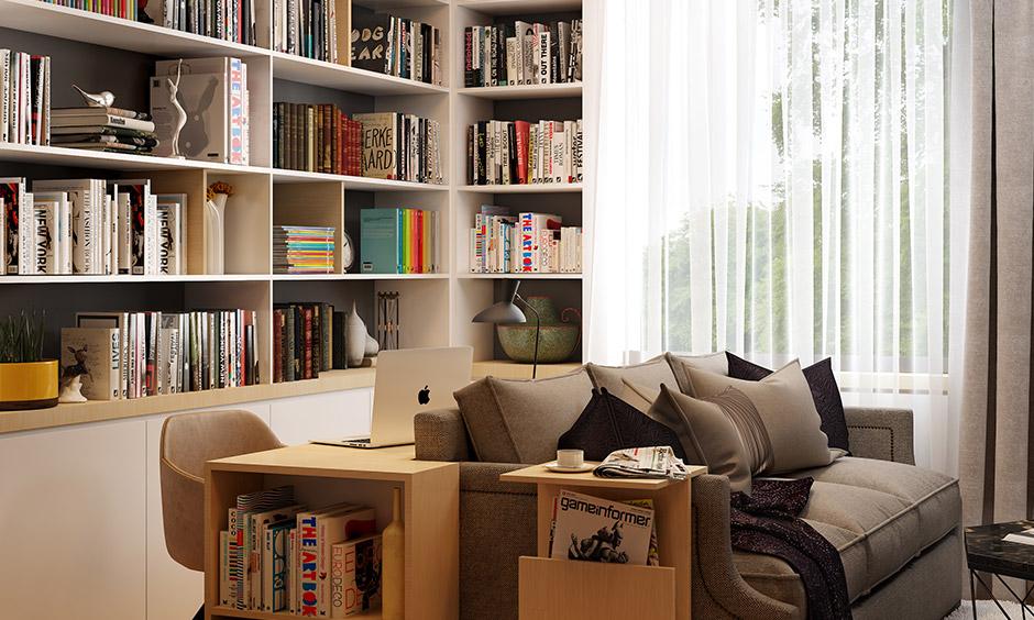 Compact home office with a sofa-back workstation and built-in bookshelves for stylish storage.