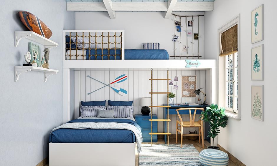 Nautical bunk bed for boys with rope safety rails and built-in study area.