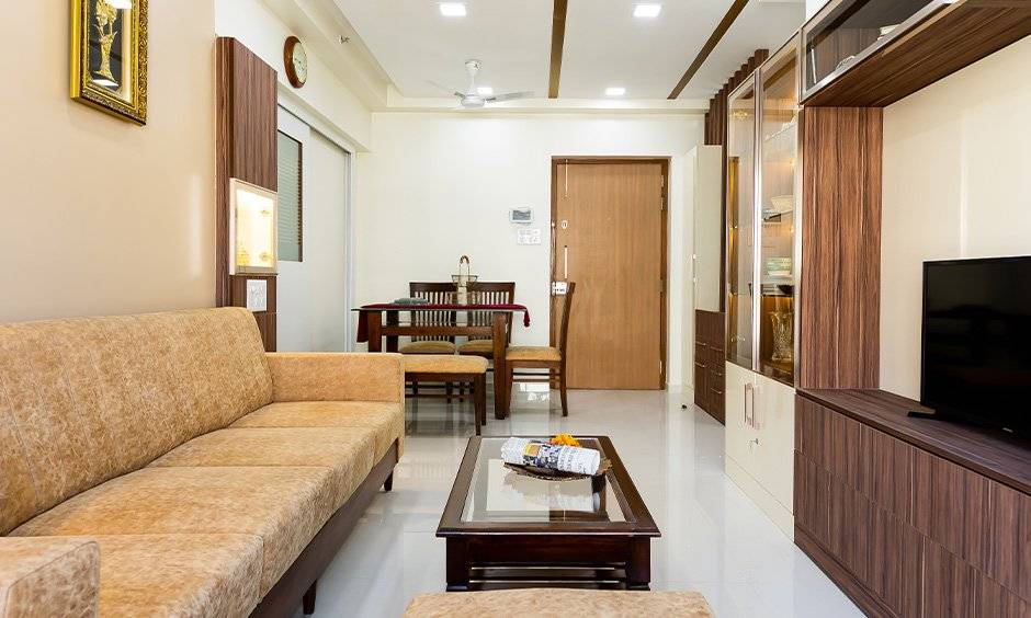 Living room interiors with dining table designed by famous interior designers in mumbai