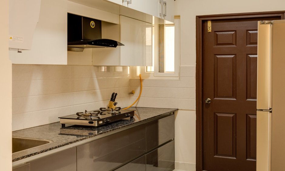 Customised kitchen featuring glossy overhead, base, and loft storage in Vijayanagar, Whitefield