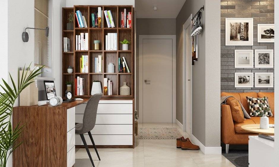 Home office desk extends to a wooden folding bookshelf, creating a lot of desk space