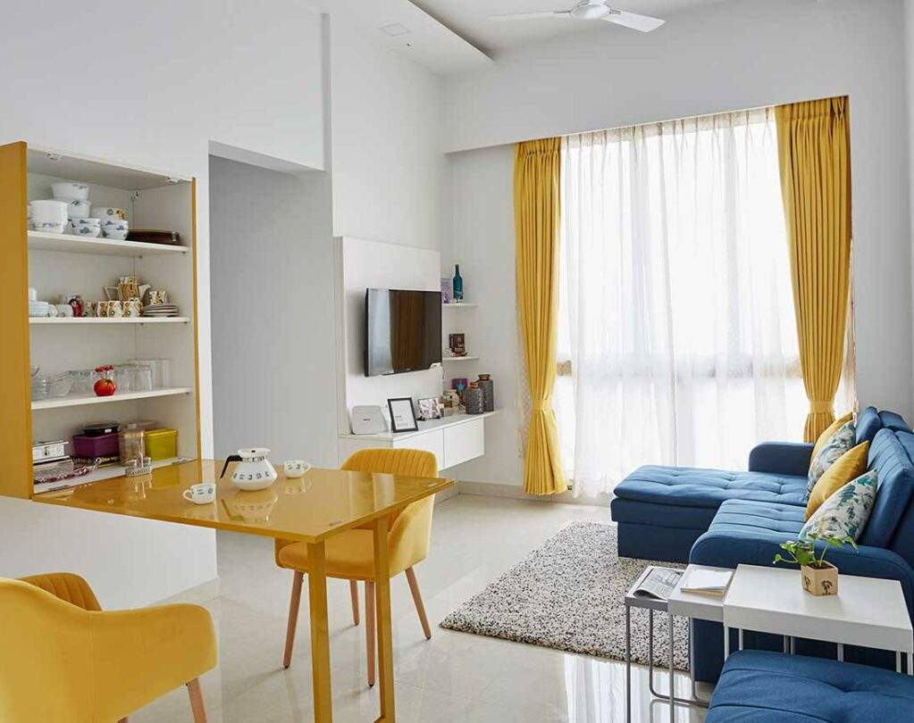 Interior decorators in mumbai for living room with a folding dining table with hidden crockery unit inside