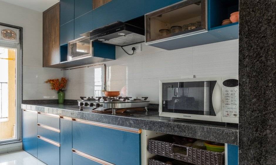 Kitchen designed with overhead and base cabinets in 2 bhk interior design cost in mumbai
