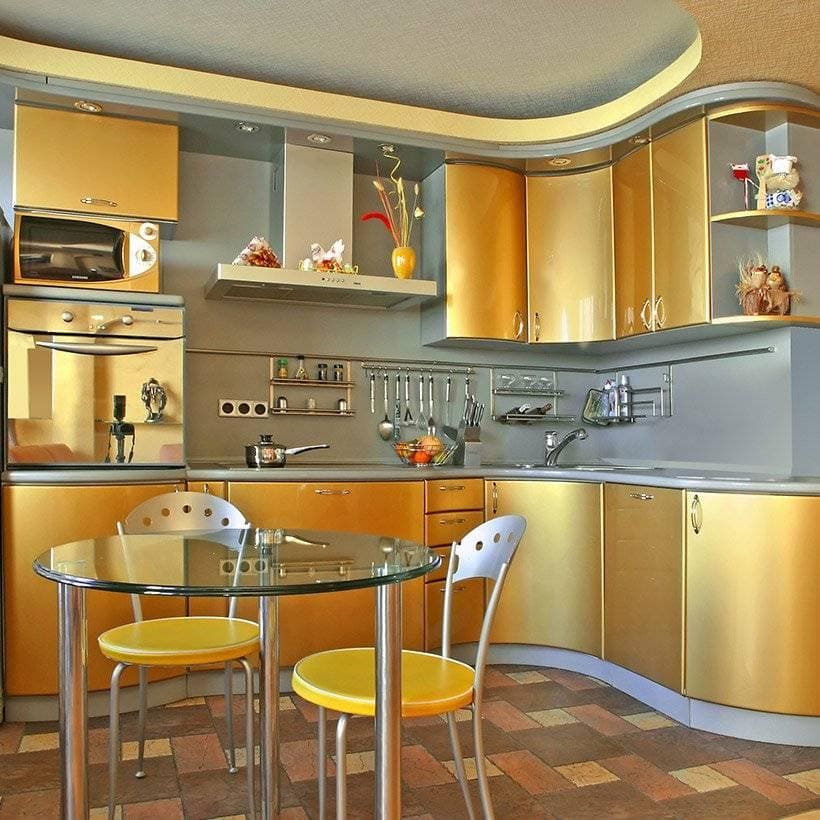 Metal kitchen cabinets with golden finish on upper and lower cabinets in curved style of kitchen cabinet doors