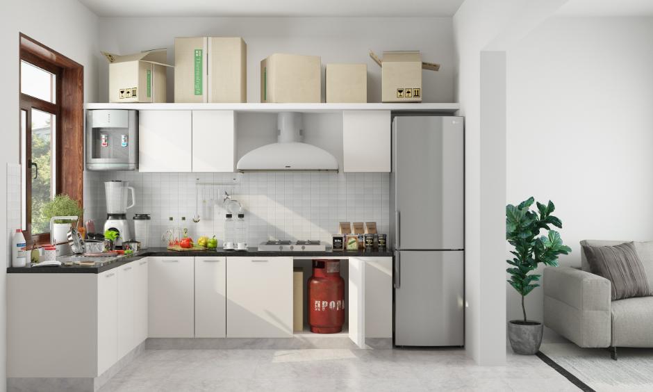 Non-modular kitchen with gas cylinder, countertop appliances and everyday storage layout.