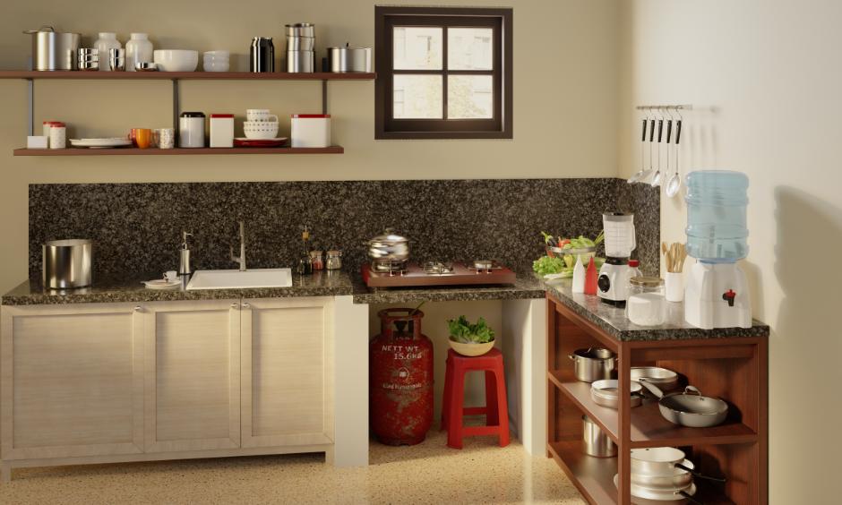Non-modular Indian kitchen with gas cylinder, wall hooks, wooden shelves and a countertop water canister.