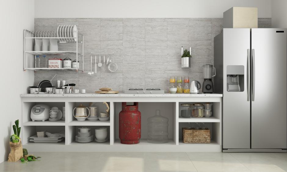 Non-modular kitchen design featuring open shelves, countertop appliances and traditional gas cylinder setup.