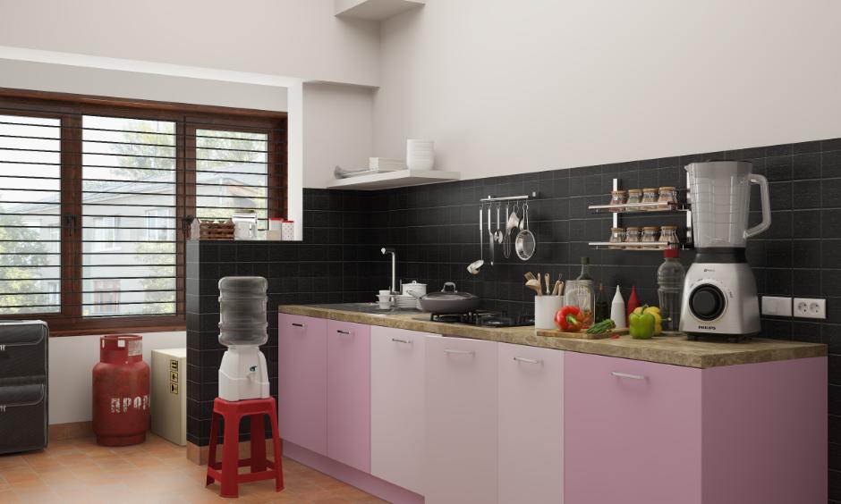 Non-modular kitchen with spice rack, open countertop, visible utilities and simple base cabinets.