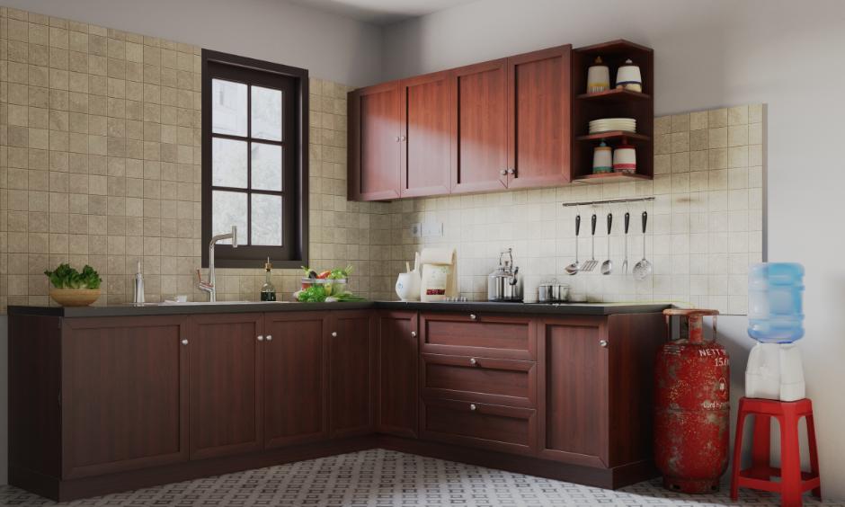 Non-modular kitchen with wooden cabinets, wall tiles and gas cylinder setup