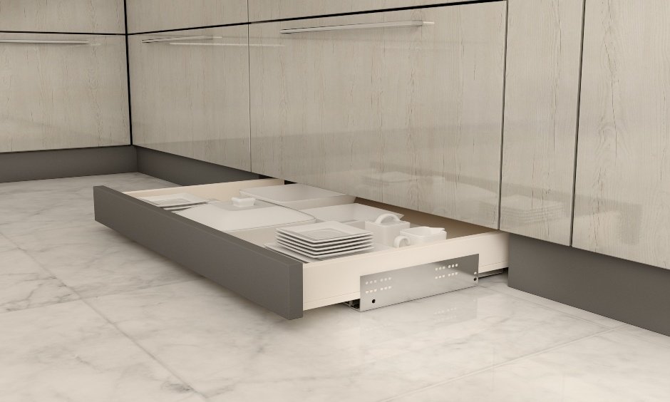Skirting drawers in l-shaped modular kitchen interiors to enhance space utilisation below cabinets