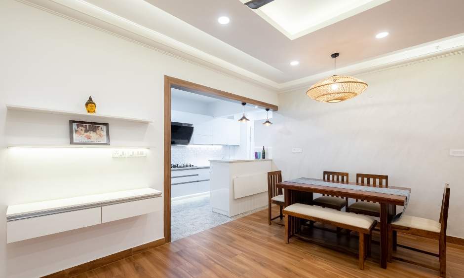 Spacious dining room interior in Sattva Greenage with wooden dining table