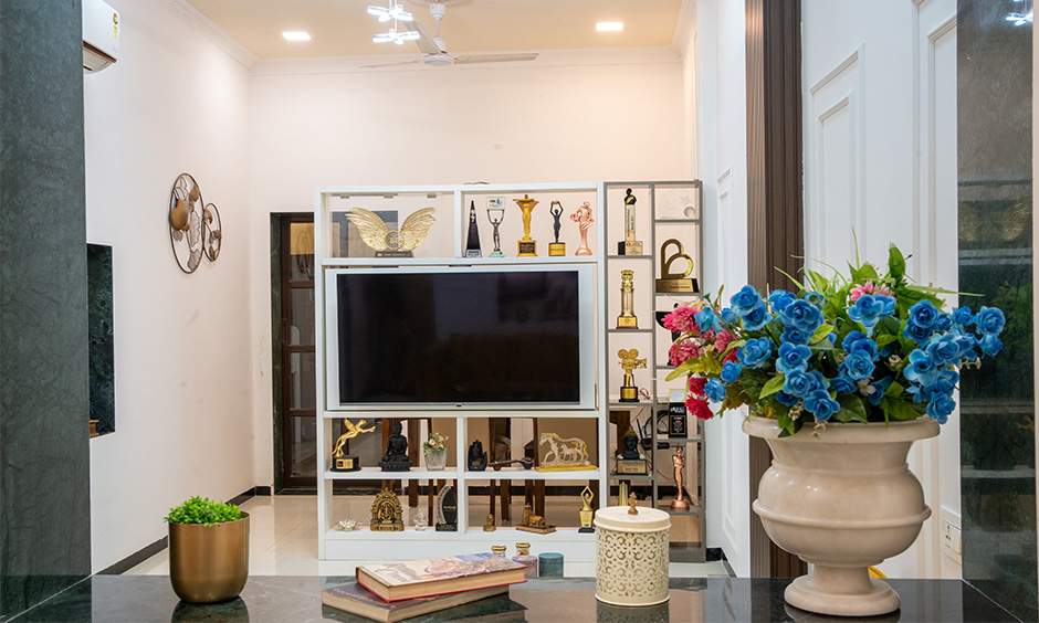 Multifunctional swivel TV unit in Tejasswi Prakash's home, enhancing space and showcasing trophies elegantly.