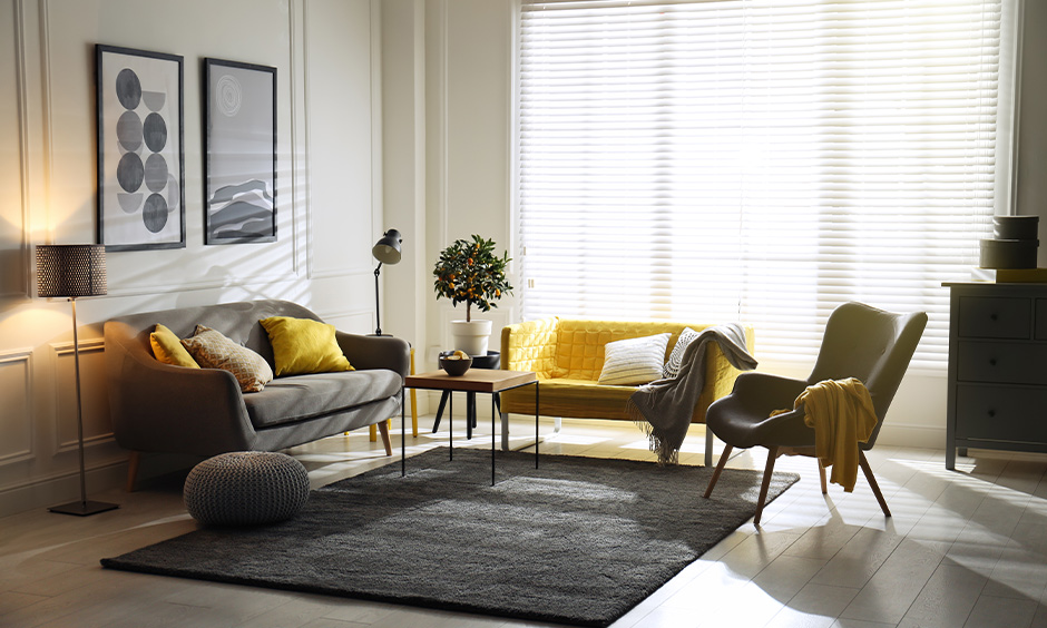 Grey and pale yellow living room with natural light and Vastu-friendly decor elements