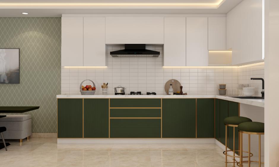 Elegant white subway tile backsplash with modern white upper cabinets, dark green lower cabinets with gold accents.